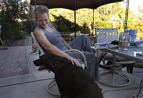 Scott Sommerdorf  |  The Salt Lake Tribune             
Kristene Bigieri with one of her five dogs. The Realtor deals with many foreclosures and short sales as a result of the mortgage crisis that has devastated the Reno area.