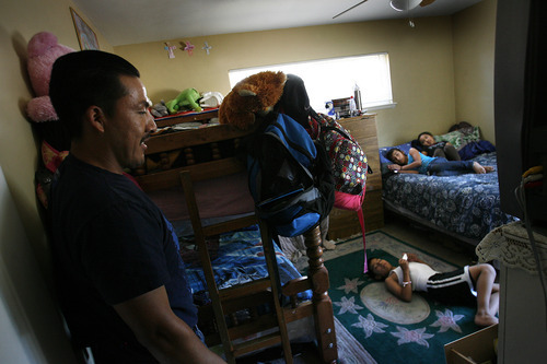 Scott Sommerdorf  |  The Salt Lake Tribune             
Mauro Soriano checks on his three children -- who live in one bedroom in the home now sheltering his family, his brother and his parents.