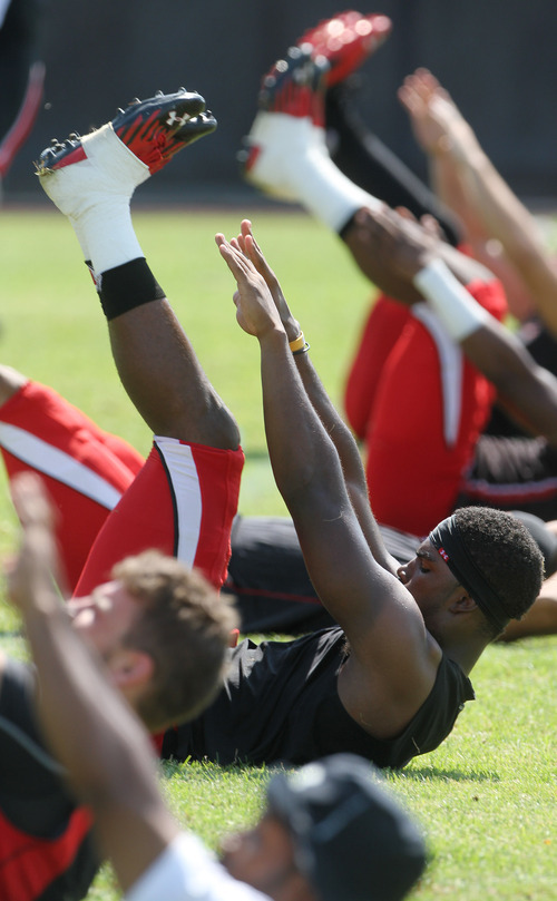 Lennie Mahler  |  The Salt Lake Tribune
Utah football players perform stretching exercises during practice Saturday, Aug. 11, 2012.