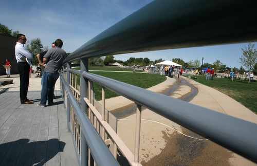 Steve Griffin | The Salt Lake Tribune

Residents enjoy the new Fairbourne Station Promenade, a four-acre park in West Valley City on Thursday. The park has an iconic pavilion, water features and an interactive scale.