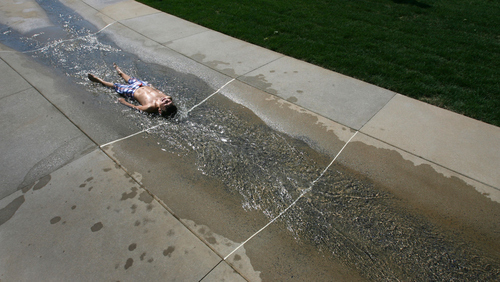 Steve Griffin | The Salt Lake Tribune


Braeden Fischer, 8, enjoys the water feature at the new Fairbourne Station Promenade, a four-acre park located behind the West Valley City Hall in West Valley City, Utah Thursday August 2, 2012.  The park has interactive features, including a scale that will depict the weight of a group of people standing on it in terms of chickens, cows and bales of hay.
