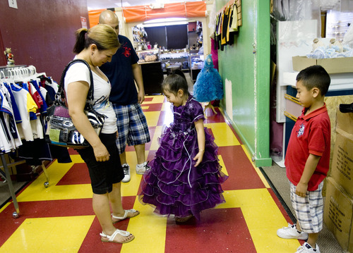 Kim Raff | The Salt Lake Tribune
Sayra Reyes shows off a dress for a quiceanera to her mother (left) Catalina Reyes at the Azteca Indoor Bazaar and Swap Meet in West Valley City on July 19, 2012.