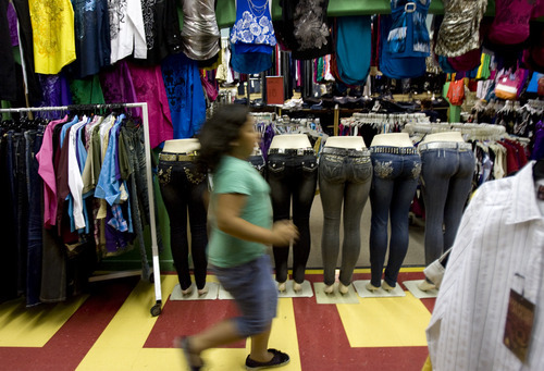 Kim Raff | The Salt Lake Tribune
A girl runs past a clothing store at the Azteca Indoor Bazaar and Swap Meet in West Valley City on July 19, 2012.