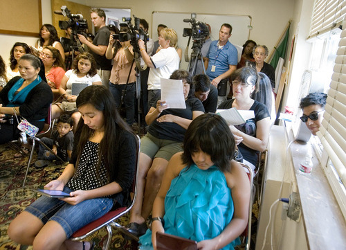 Paul Fraughton | The Salt Lake Tribune
A packed room of  people, some peeking through open windows, listen to speakers Wednesday, August 15, 2012, at a meeting laying out details of President Obama's deferred action program.  Speakers at the meeting  held at the Salt Lake Dream Team Office, announced the launch of workshops that will help people who want to apply for the program.