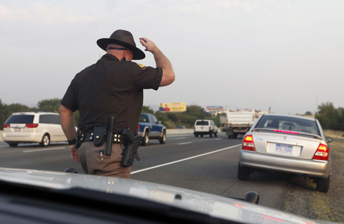 Al Hartmann  |  The Salt Lake Tribune  
Trooper Emery Calkins heads out to write a warning to another motorist violating Utah's express-lane laws. During a three-day enforcement blitz that ran through Thursday, troopers wrote warnings to educate drivers.