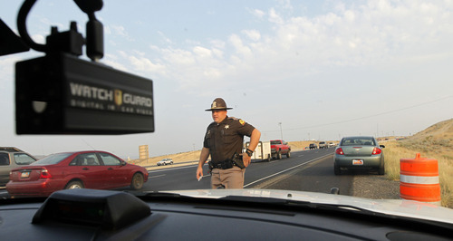 Al Hartmann  |  The Salt Lake Tribune  
Utah Highway Patrolman Emery Calkins pulls over a driver while patrolling  I-15 in Utah County Thursday morning August 16 during the morning rush hour. He was on the lookout for  motorists illegaly driving in the express-HOV lane.  This person was driving in the lane with only one occupant and illegaly crossing the double white line to enter the express lane.  She was not given a ticket this time but Calkins used the opportunity to educate her on the laws of use for the express lane.