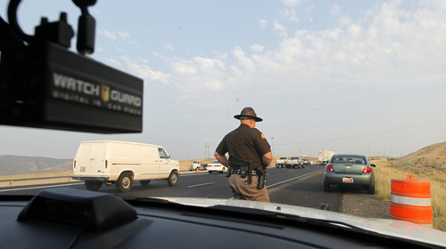 Al Hartmann  |  The Salt Lake Tribune  
Utah Highway Patrolman Emery Calkins pulls over a driver while patrolling  I-15 in Utah County Thursday morning August 16 during the morning rush hour. He was on the lookout for  motorists illegaly driving in the express-HOV lane.  This person was driving in the lane with only one occupant and illegaly crossing the double white line to enter the express lane. She was not given a ticket this time but Calkins used the opportunity to educate her on the laws of use for the express lane.