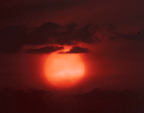 Trent Nelson  |  The Salt Lake Tribune
The setting sun burns through the haze over Salt Lake City on Thursday, Aug. 16, 2012.