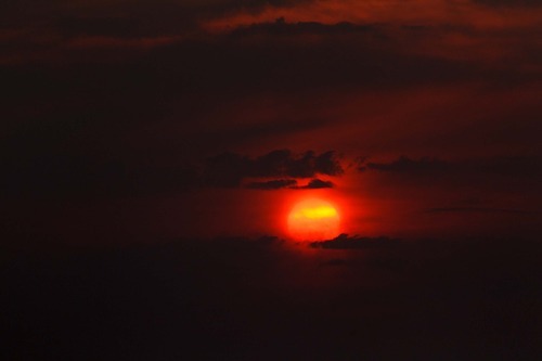 Trent Nelson  |  The Salt Lake Tribune
The setting sun burns through the haze over Salt Lake City on Thursday, Aug. 16, 2012.