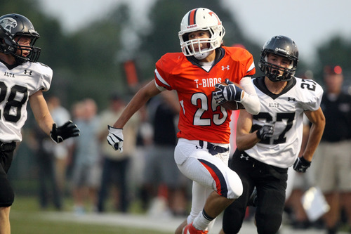 Chris Detrick  |  The Salt Lake Tribune
Timpview's Connor Mendivil (25) runs past Alta's Jake Owen (28) and Alta's Brandon Smart (27) during the game at Timpview High School Friday August 17, 2012.