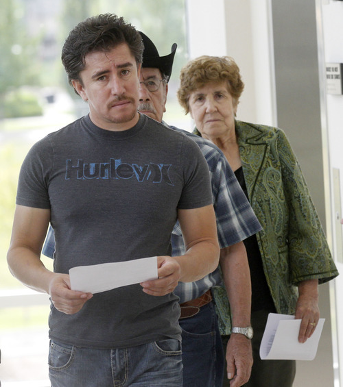 Al Hartmann  |  The Salt Lake Tribune  
Mike, left, Jacinto and Juliana Roman, (brother, father and mother) of Roberto Roman enter Fourth District Court in  Spanish Fork on Monday, Aug. 13 for jury selection for his murder trial.   He is accused of killing Millard County Deputy Josie Greathouse Fox.