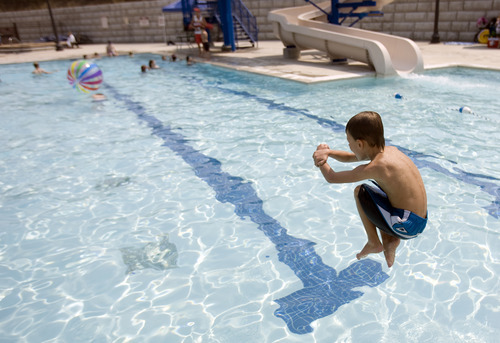Kim Raff |  The Salt Lake Tribune
Asher Moody does a cannon ball into the pool at the Suncrest Community Pool in Draper, Utah on August 15, 2012. Asher's parents decided it would be best for him to start kindergarten at Summit Academy this month -- after he turned 6 on Aug. 1 -- rather than a year ago, when he'd barely turned 5 by the first day of school.