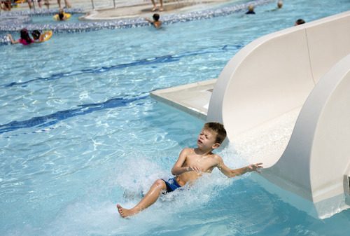 Kim Raff |  The Salt Lake Tribune
Asher Moody goes down the water slide at the Suncrest Community Pool in Draper, Utah on August 15, 2012. Asher's parents decided it would be best for him to start kindergarten at Summit Academy this month -- after he turned 6 on Aug. 1 -- rather than a year ago, when he'd barely turned 5 by the first day of school.