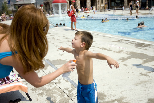 Kim Raff |  The Salt Lake Tribune
Amanda Moody sprays suntan lotion on her son, Asher Moody, before he swims at the Suncrest Community Pool in Draper, Utah on August 15, 2012. Asher's parents decided it would be best for him to start kindergarten at Summit Academy this month -- after he turned 6 on Aug. 1 -- rather than a year ago, when he'd barely turned 5 by the first day of school.