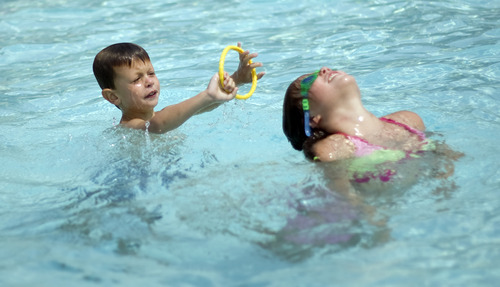 Kim Raff |  The Salt Lake Tribune
Asher Moody plays with his sister, Tessa Moody, in the Suncrest Community Pool in Draper, Utah on August 15, 2012.  Asher's parents decided it would be best for him to start kindergarten at Summit Academy this month -- after he turned 6 on Aug. 1 -- rather than a year ago, when he'd barely turned 5 by the first day of school.