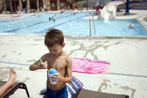 Kim Raff |  The Salt Lake Tribune
Asher Moody eats a snack while taking a break from swimming in the Suncrest Community Pool in Draper, Utah on August 15, 2012. Asher's parents decided it would be best for him to start kindergarten at Summit Academy this month -- after he turned 6 on Aug. 1 -- rather than a year ago, when he'd barely turned 5 by the first day of school.