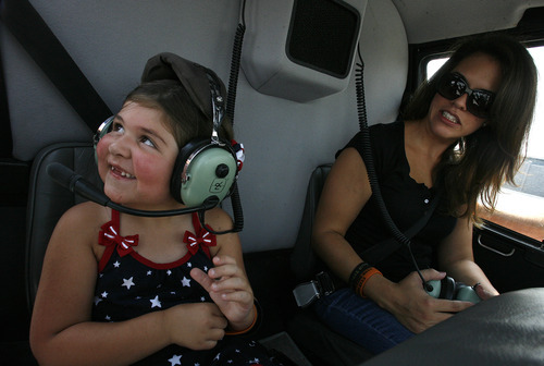 Scott Sommerdorf  |  The Salt Lake Tribune             
Agent Jared Francom's daughter Samantha, left, and his widow, Erin, get settled in the helicopter donated by Utah Helicopter that would take them along the ride route to the state Capitol, Sunday, August 19, 2012.
