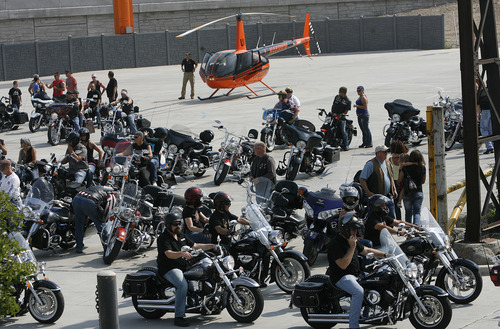 Scott Sommerdorf  |  The Salt Lake Tribune             
A fraction of the riders head out as the helicopter that will take Agent Jared Francom's family along the ride route to the state Capitol waits in the background, Sunday, August 19, 2012.