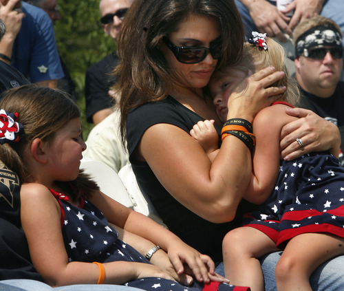 Scott Sommerdorf  |  The Salt Lake Tribune             
Erin Francom, widow of Agent Jared Francom, holds daughter Hailey with daughter Samantha at left during a ceremony honoring fallen officers, Sunday, at the Capitol.