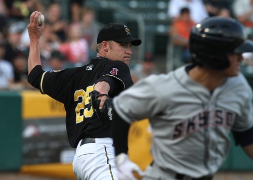 Rick Egan  | The Salt Lake Tribune 
 
Salt Lake Bees pitcher, Greg Smith, fields a bunt and throws to first as Tommy Field tries to run out the bunt, in baseball action, Salt Lake Bees, v.s. the Colorado Springs, Sky Sox, Monday, August 20, 2012.