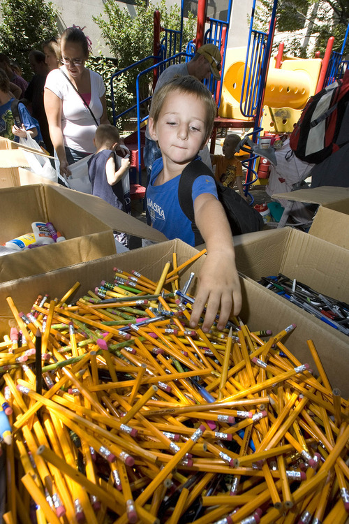 Paul Fraughton | Salt Lake Tribune
Skyler Coulten-Slaten, age 7, reaches into a large box filled with pencils as he  fills his bag with school supplies. He was one  of the 150 school aged children living at  The Road Home Shelter who received  back to school  items  thanks to the Apple Tree Program, a four week campaign by the shelter to collect new clothing and school supplies. Apple Trees with paper apples attached, featuring specific children's needs, were set up at various business in the area and participants  bought  items for their chosen  child.
 Monday, August 20, 2012