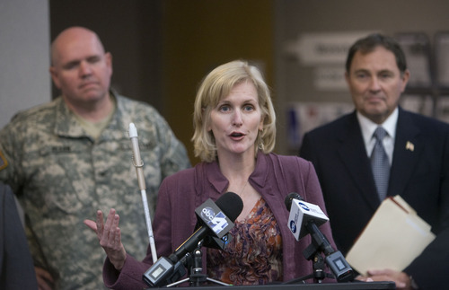 Al Hartmann  |  The Salt Lake Tribune
Kristen Cox, executive director for Utah Workforce Services, speaks at a 2011 press conference flanked by Col. Scott Olson of the Utah National Guard and Utah Gov. Gary Herbert. The governor  on Tuesday, Aug. 21, 2012, named her the new head of the Governor's Office of Management and Budget.