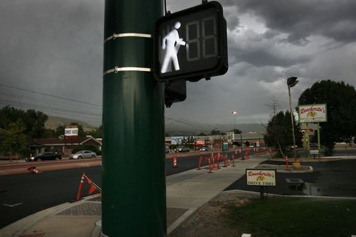 Scott Sommerdorf  |  The Salt Lake Tribune             
Pedestrian signs on North Temple, Friday, August 11, 2012. 
Barbara Brown, an environmental psychologist with the University of Utah Department of Family and Consumer Studies, is leading research to determine whether walkable neighborhoods impact health. She will rig hundreds of participants who live near North Temple with devices that will monitor their movements now and a year later after North Temple project has been completed and the place becomes a pedestrian's paradise