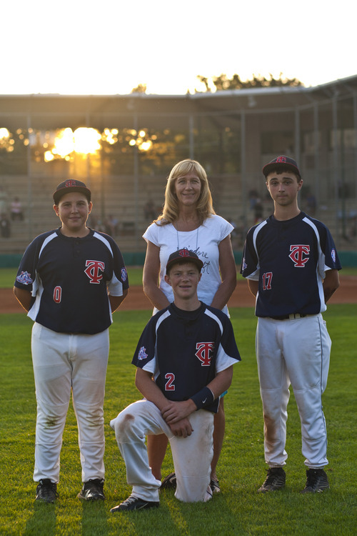 Chris Detrick  |  The Salt Lake Tribune
Host parent Kathy Chism poses for a portrait with Twin Cities, WA players Garrett Hicks, Nolan Wasson and Jake Sutton at Ken Price Park Thursday August 23, 2012.