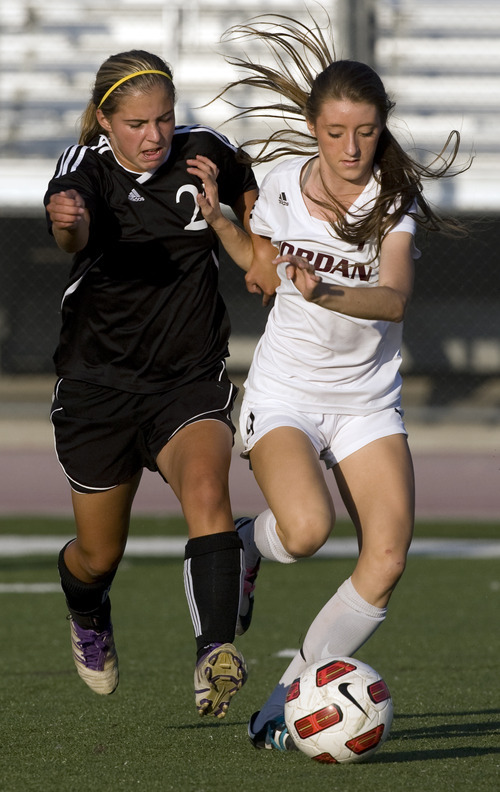 Kim Raff | The Salt Lake Tribune
Jordan High School player (right) Jacqueline Williams and Murray player Lizzie Braby battle for the ball during a girls soccer game at Jordan High School in Sandy, Utah on August 23, 2012.