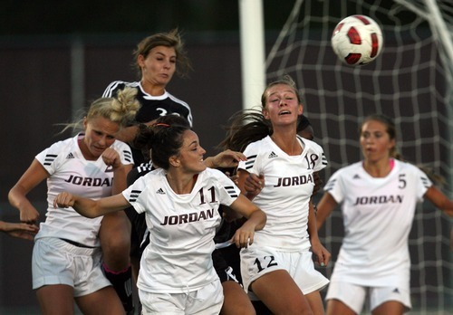 Kim Raff | The Salt Lake Tribune
Jordan High School player (from left) Ashlie Miller, Whitney Tuckfield and Amanda Durrant battle for a ball in the air with Murray player Breanna Archuleta during a girls soccer game at Jordan High School in Sandy, Utah on August 23, 2012.