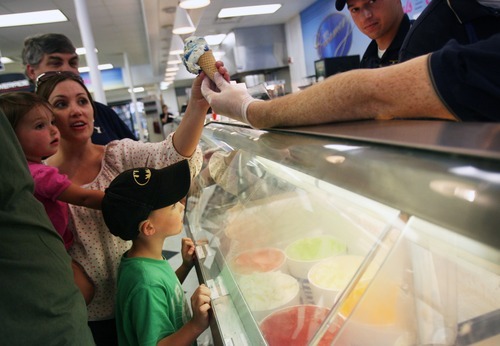 Kim Raff  |  The Salt Lake Tribune
Olivia, left, and Stephanie Henderson reach for an ice cream cone as Lucas Henderson looks at his flavor choices at the BYU Creamery on Ninth in Provo on Aug. 2, 2012.