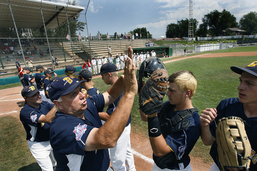 Scott Sommerdorf  |  The Salt Lake Tribune             
Manager Bill Mosca slaps hands with his team as the Branchburg (NJ) Bulldogs are introduced prior to the championship game. The Branchburg (NJ) Bulldogs defeated the Jacksonville (FL) Ospreys 7-5 to win the Babe Ruth World Series, Saturday, August 25, 2012 in Murray.