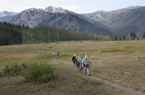 Scott Sommerdorf  |  The Salt Lake Tribune             
A group led by Rep. Joel Briscoe, D-Salt Lake City, hikes Saturday through a meadow near where the proposed SkiLink gondola project would go through. Save Our Canyons and other environmental groups held a press conference to denounce the SkiLink proposal and tout what they contend is growing opposition to the idea.