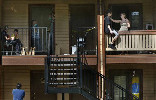Scott Sommerdorf  |  The Salt Lake Tribune             
Neighbors watch as police investigators search the apartment at 6999 S. State Street, #1503, where a man was shot to death Sunday, August 26, 2012 in Midvale.
