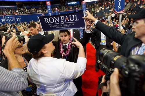 Trent Nelson  |  The Salt Lake Tribune
A Ron Paul banner is pulled away from delegate Braedon Wilkerson at the Republican National Convention in Tampa, Fla.,  onTuesday.