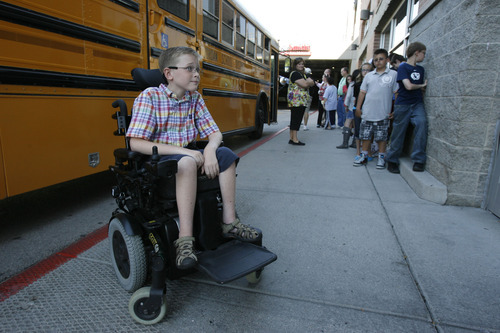 Francisco Kjolseth  |  The Salt Lake Tribune
Carter Veldevere, a 6th grader from Hayden Peak Elementary in West Jordan who has spinal muscular atrophy, waits for a special event to begin alongside his classmates at the Smith's at 455 S. 500 E. in Salt Lake City on Tuesday. The 10-year-old received a sponsorship from Milk-Bone and Smith's Food & Drug, and will be matched with a free service dog some time in the next year.