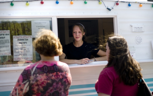 Kim Raff | The Salt Lake Tribune
Rachel Howard takes an order for shaved ice at the Wasatch Pops stand in Salt Lake City on Aug. 24, 2012.
