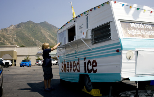 Kim Raff | The Salt Lake Tribune
Seth West orders a shaved ice at the Wasatch Pops stand in Salt Lake City on Aug. 24, 2012.