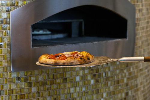 Chris Detrick  |  The Salt Lake Tribune
Salsiccia pizza ($7.95) made with house marinara, mozzarella, parmigiano reggiano, fennel sausage, tomatoes, red onions, kalamata olives, olive oil and basil at Pizzeria Limone.