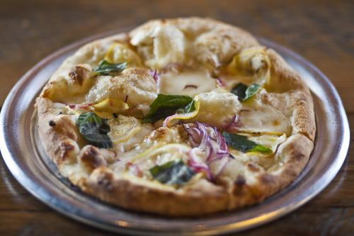 Chris Detrick  |  The Salt Lake Tribune
Limone Pizza ($8.95) made with olive oil, mozzarella, parmigiano reggiano, lemons, red onions, garlic and basil at Pizzeria Limone in Cottonwood Heights.