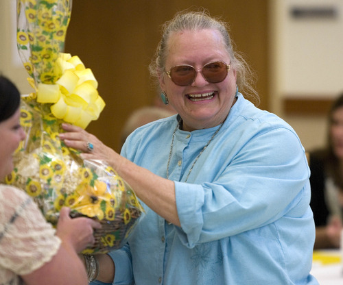 Paul Fraughton | Salt Lake Tribune
Deborah Van Natta smiles as she receives a gift basket for being named the 100,000th person to be served lunch at the Taylorsville Senior Center. Wednesday, August 29, 2012