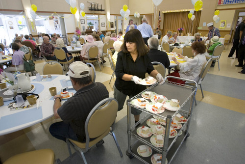 Paul Fraughton | Salt Lake Tribune
Lillian Brito, a volunteer at the Taylorsville Senior Center, passes out pieces of cake to seniors eating their lunch at the center. The special treat was part of the celebration of the 100,000th lunch served there. Wednesday, August 29, 2012