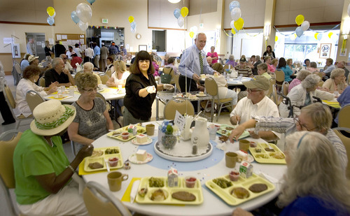 Paul Fraughton | Salt Lake Tribune
Lillian Brito, a volunteer at the Taylorsville Senior Center, and Taylorsville City Councilman Ernest Burgess, pass out pieces of cake to seniors eating their lunch at the center. The special treat was part of the celebration of the 100,000th meals served there. Wednesday, August 29, 2012.