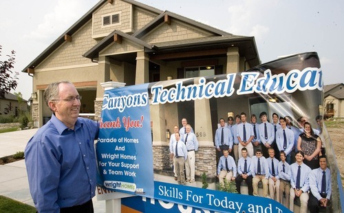Paul Fraughton | The Salt Lake Tribune
Ken Spurlock, principal of The Canyons Technical Educational Center, stands next to a poster showing some of the students from the CTEC program that helped build  the home at 569 E. Rosebowl Court, in Sandy. The house is featured as part of the Parade of Homes home show.