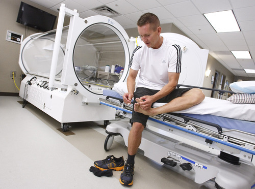 Leah Hogsten  |  The Salt Lake Tribune
William Calton inspects his formerly frostbitten foot at Ogden Regional Medical Center's Wound Care and Hyperbaric Center. This past spring, Calton barely survived a deadly traffic jam on Mount Everest.