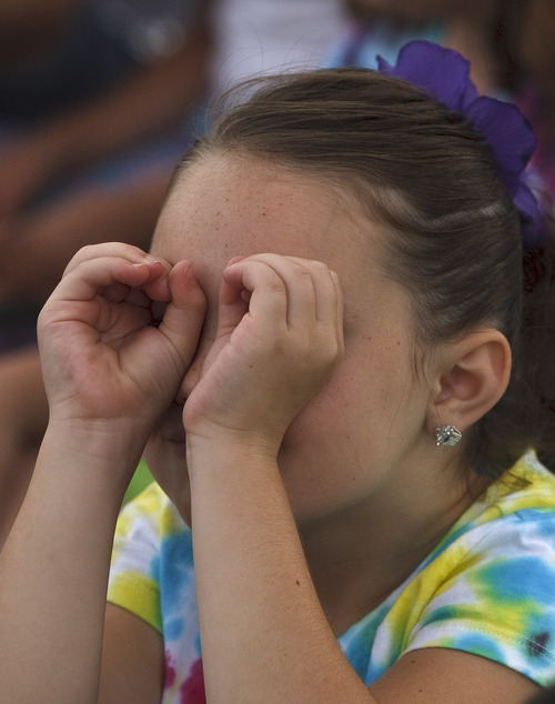 Leah Hogsten  |  The Salt Lake Tribune
Megan Bodrero, a Bluff Ridge Elementary School second-grader, peaks at the hot air balloon through her hands. Students at Bluff Ridge Elementary School enjoyed a lesson about the aerodynamics of hot air balloon flying August 30, 2012.