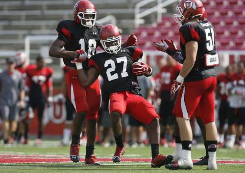 Scott Sommerdorf  |  The Salt Lake Tribune             
Former Alta High player Tyron Morris-Edwards, #27, gets congratulated by team mates after he intercepted a pass thrown by QB Jon Hays during Utah football practice, Saturday, August 18, 2012.
