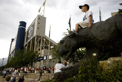 Kim Raff | The Salt Lake Tribune
Isaac Allen sits on top of the cougar statue outside of Lavell Edwards stadium before the BYU and Washington State home opener in Provo on Aug. 30, 2012.