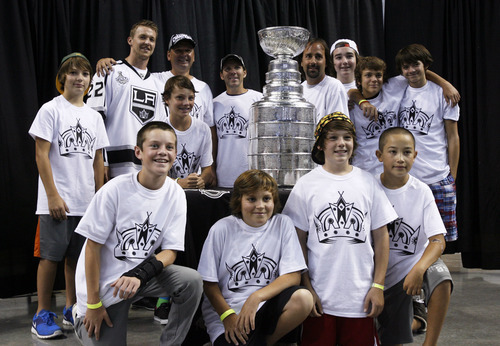 Francisco Kjolseth  |  The Salt Lake Tribune
Members of the Park City Ice Miners get a chance to meet Trevor Lewis, second from left, who played hockey for Brighton High School as he brings the Stanley Cup home for a day as a member of the NHL champion Los Angeles Kings. Thousands of fans lined up at the Maverik Center in West Valley City on Thursday, August 30, 2012, for a chance to pose for a picture with Lewis and the Cup.