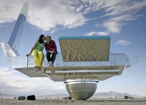 Rick Egan  |  The Salt Lake Tribune 
Randall Leeds and Elise Fande, of San Francisco, share a kiss on the Cosmic Carousel at Burning Man, the annual arts festival in the Black Rock Desert in Nevada.